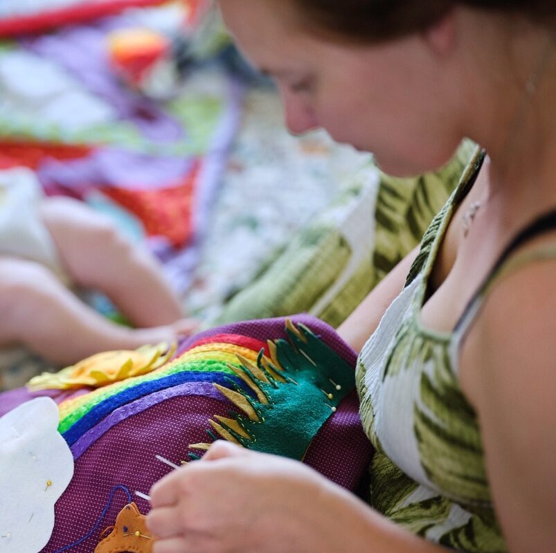 A woman sewing a sensory bag