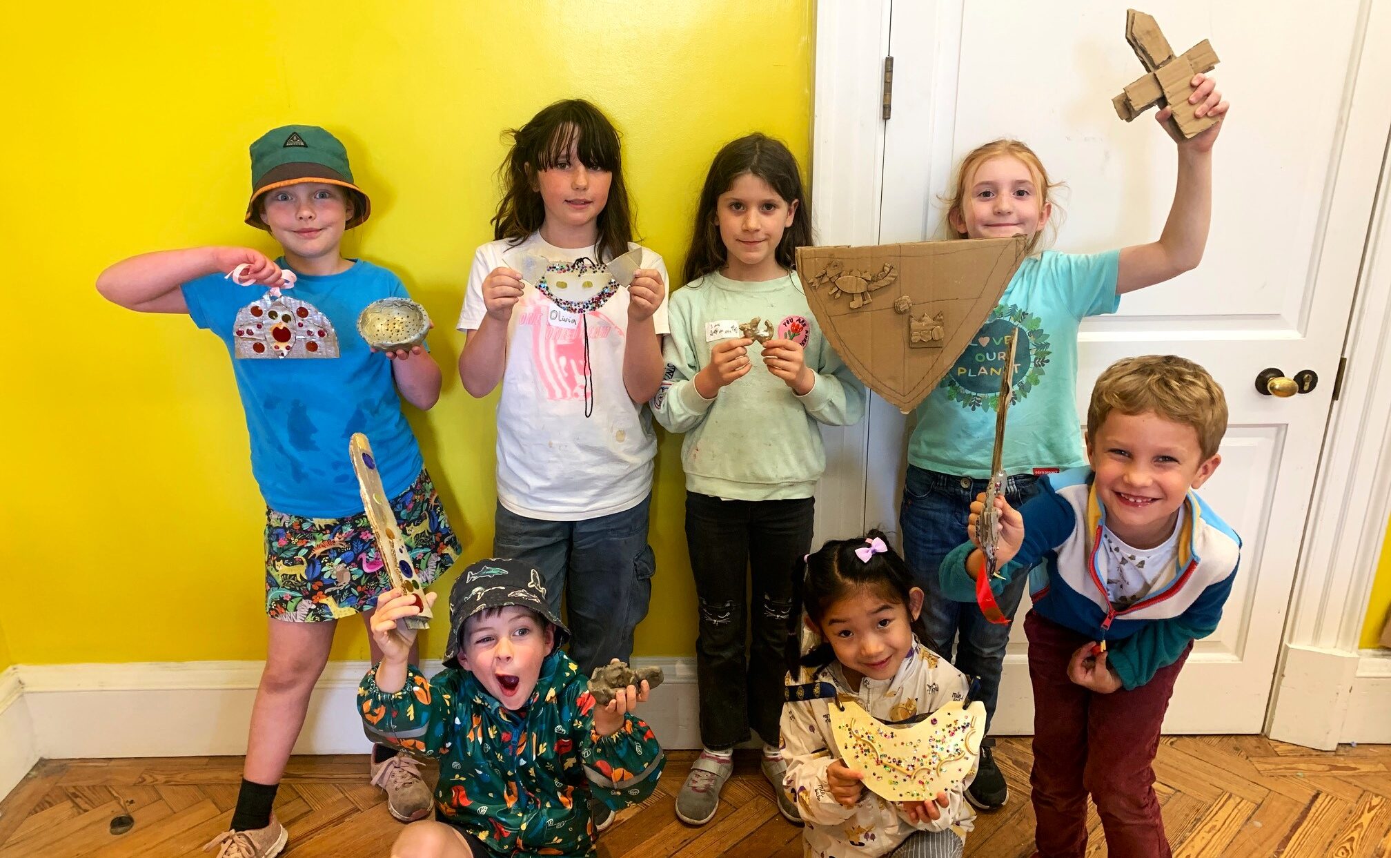 Children showing what they've made in a workshop